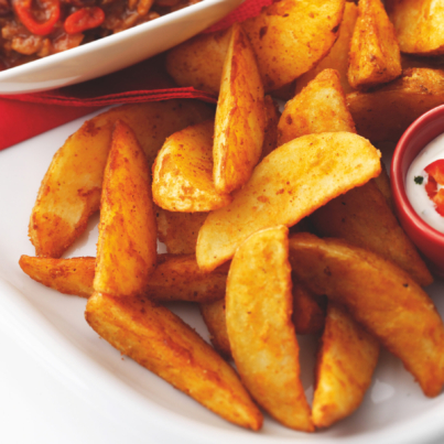 Classic Spicy Wedges with Chilli and dip on a platter